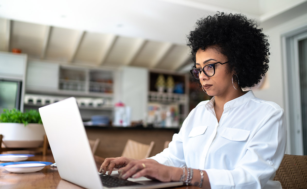 Woman typing on laptop.