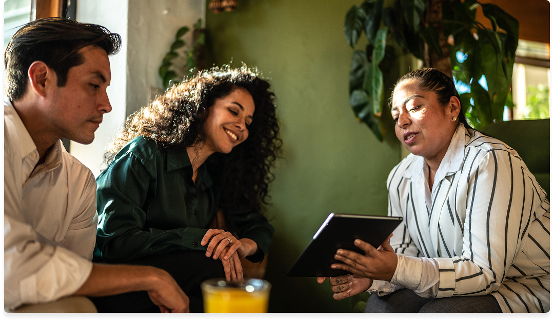 An insurance agent explains policy options to a young couple