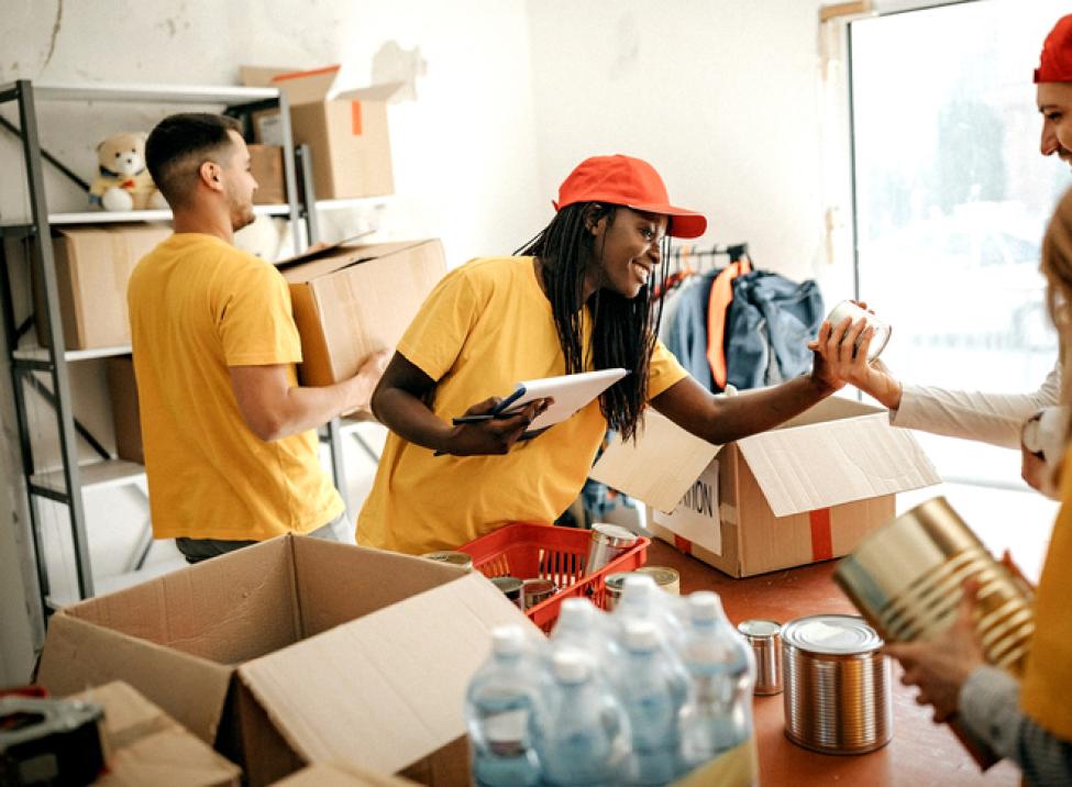 Group of people packaging food and water.