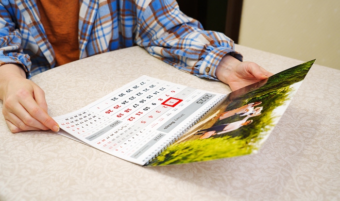 Person holding a calendar with a date circled