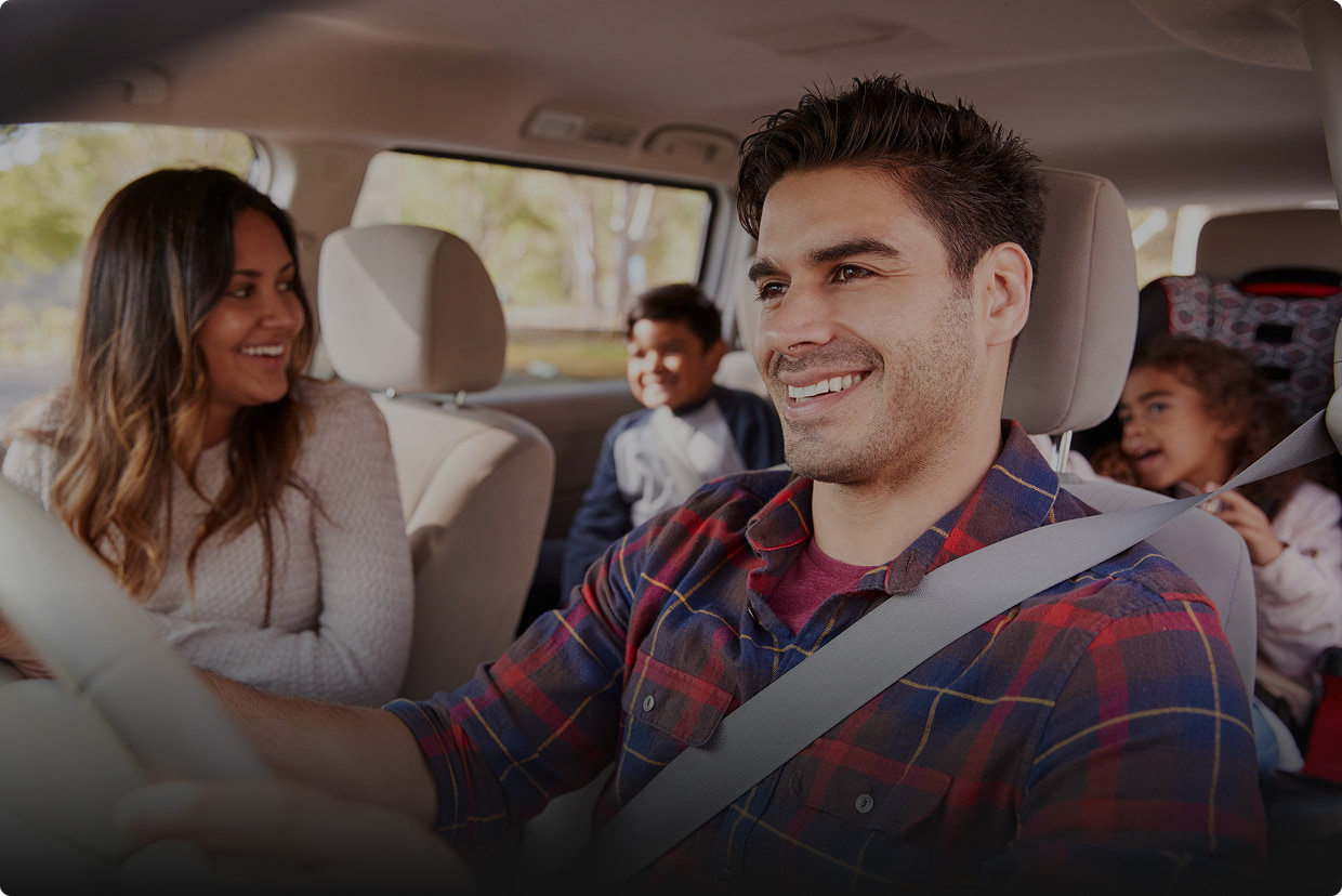 Photo of a happy family in their car